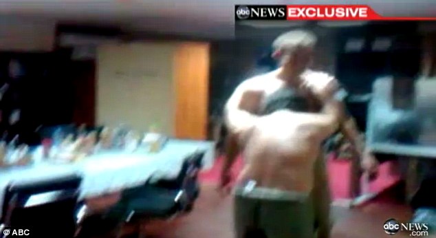 Outlandish behavior: As two of the men wrestle, bottle of alcohol - which is supposed to be forbidden - can be seen lined up in the background